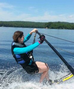 Rebecca using Pink general purpose gripping aid to hold onto waterski