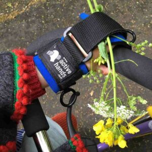 Mini gripping aid for children. Blue gripping aid on trike. Suitable for reduced hand function: tetra, quad, cerebral palsy, SCI, spinal cord injury, stroke and more.