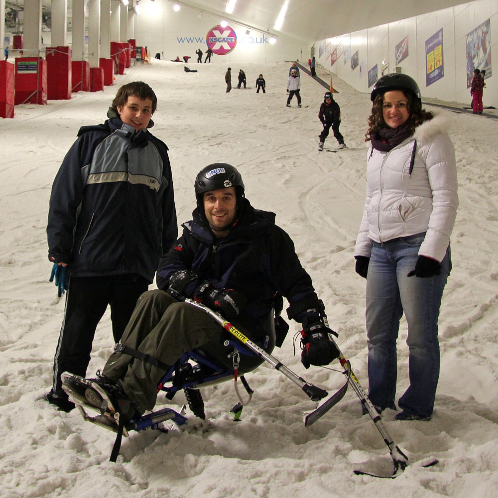 Winter sports gripping aid being used on sit ski. Suitable for reduced hand function: tetra, quad, cerebral palsy, SCI, spinal cord injury, stroke and more.