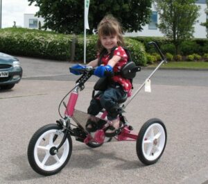 Girl holding bike handles with mini aids