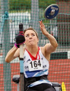 Josie Pearson using our pink general purpose aid to steady herself during competing in discus.