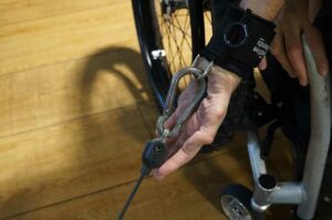 D-ring aid in gym attached to karabiner. Adaptive gym equipment. Suitable for reduced hand function: tetra, quad, cerebral palsy, SCI, spinal cord injury, limb difference, stroke and more.