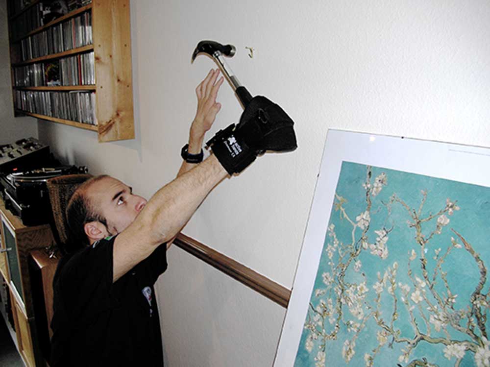 Rob using General Purpose aid to hold hammer. Suitable for reduced hand function: tetra, quad, cerebral palsy, SCI, spinal cord injury, limb difference, stroke and more.