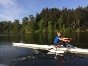 Veronique using looped to row on lake. Adaptive gym equipment. Suitable for reduced hand function: tetra, quad, cerebral palsy, SCI, spinal cord injury, limb difference, stroke and more.