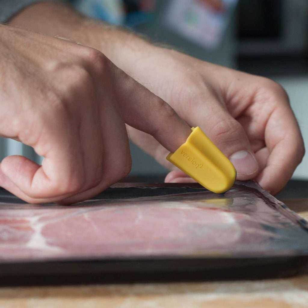nimble being used to slice through bacon packaging to help with reduced hand function