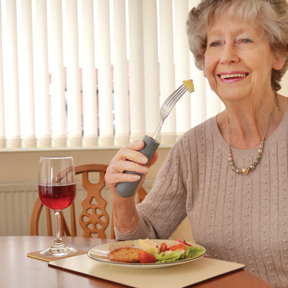 woman using fork in cutlery grip. Adaptive kitchen equipment. Suitable for reduced hand function: tetra, quad, cerebral palsy, SCI, spinal cord injury, stroke and more.