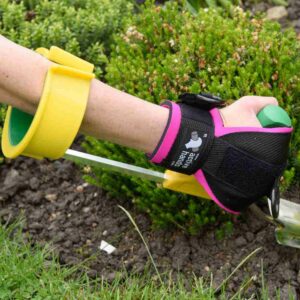 active hands general purpose aid being used to grip the right angled trowel to help with gardening with reduced hand function