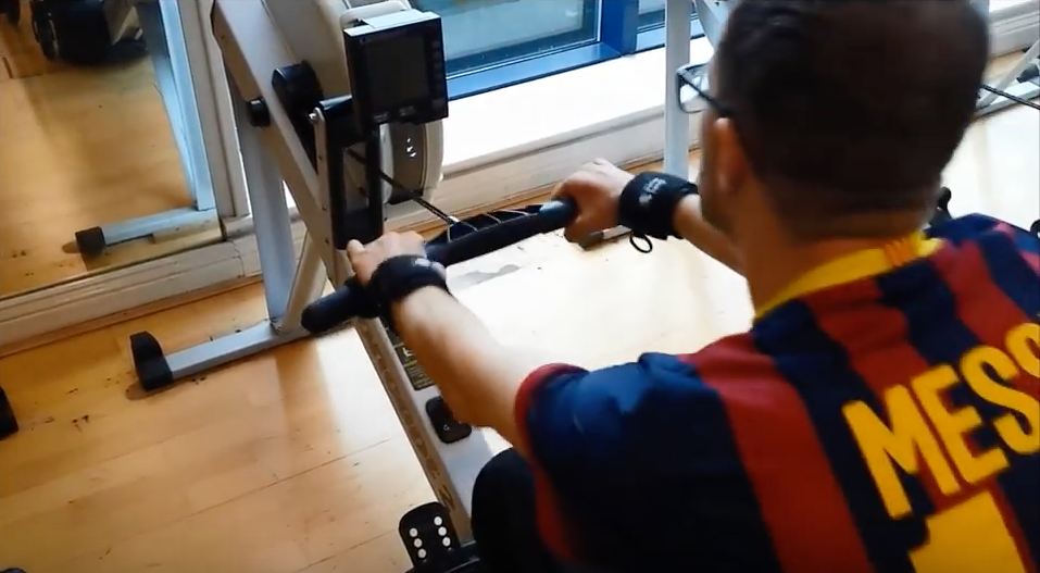 Gareth on rowing machine with Looped aids. Adaptive gym equipment. Suitable for reduced hand function: tetra, quad, cerebral palsy, SCI, spinal cord injury, stroke and more.
