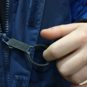 Zip grip zip pull on blue child's coat. Suitable for reduced hand function: tetra, quad, cerebral palsy, SCI, spinal cord injury, stroke and more.