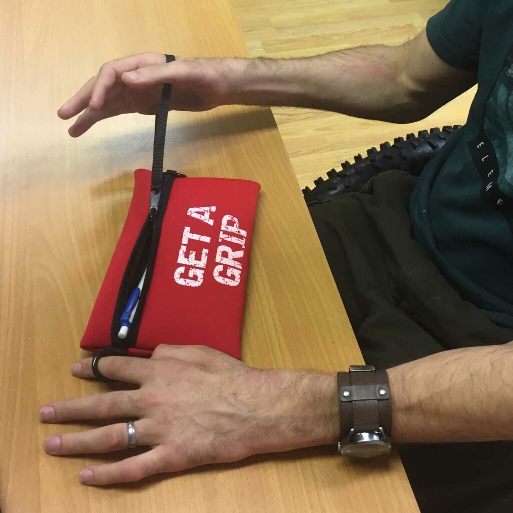 Storage pouch in use. Suitable for reduced hand function: tetra, quad, cerebral palsy, SCI, spinal cord injury, stroke and more.