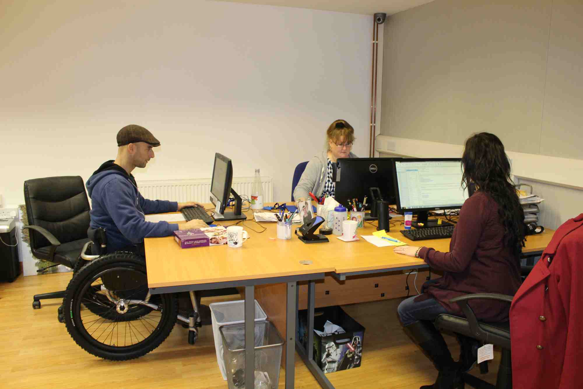 Karen, Rob and Mel working at the desks