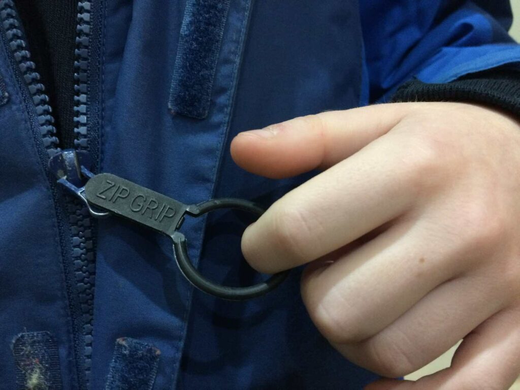 zip grip attached to zip to help people with reduced hand function zip and unzip their clothing