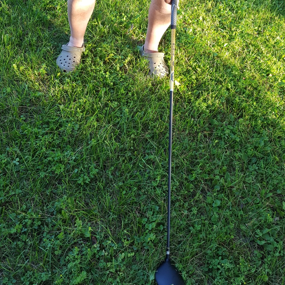 Limb difference aid holding golf club.