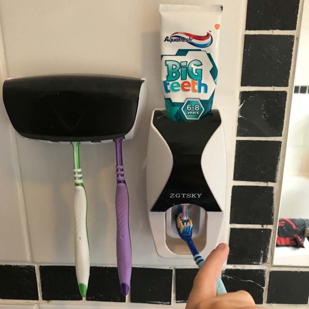 Toothpaste dispenser and holder in bathroom, toothpaste being applied. Suitable for reduced hand function: tetra, quad, cerebral palsy, SCI, spinal cord injury, stroke and more.