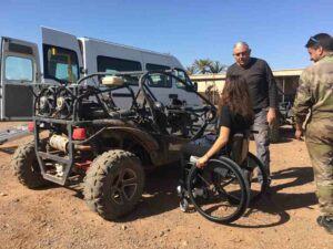 Oksana getting into off-road buggy.