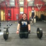 Tina weightlifting with Limb Difference aid