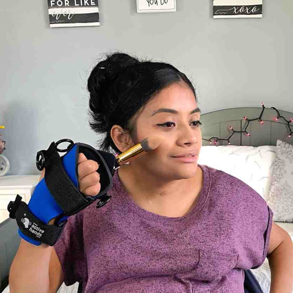 Small Item aid woman putting on make-up. Suitable for reduced hand function: tetra, quad, cerebral palsy, SCI, spinal cord injury, stroke and more.
