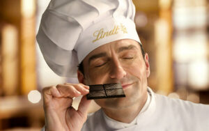 Chef sniffing Lindt chocolate with a smile on his face
