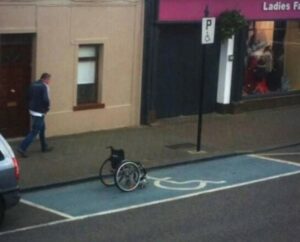 Image of lone wheelchair in disabled parking space