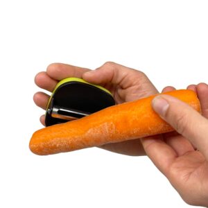 A carrot is being peeled with the palm peeler