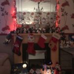 a beautifully decorated Christmassy fireplace with 4 stockings hanging on it