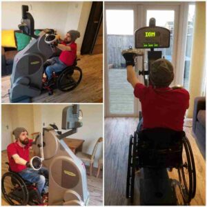 Gareth on the hand bike machine at home