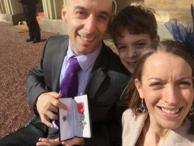 Rob with his MBE medal, wife and son