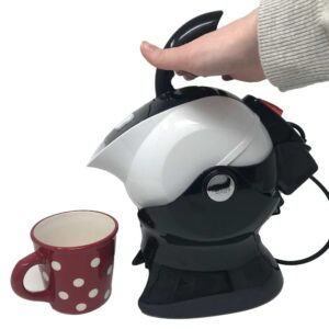 the Uccello kettle tips in it's base allowing you to pour boiling water safely if lifting a kettle is difficult for you. A red mug with white spots is waiting to receive the water