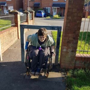 Tess wheeling under a bar outside