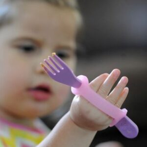 young child with plastic fork in an easy hold grip