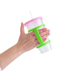 An adult hand using the EazyHold Sippy Cup strap to hold a cup with a straw