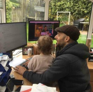 Rob works with his daughter on his lap!