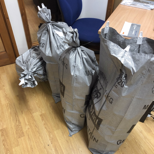 four postage sacks full of parcels ready to be posted