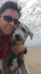 Nat with her dog Stan at the beach