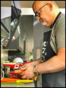 Ian from Cookfulness is peeling a carrot. He needs a palm peeler from Active Hands really but sadly, isn't using one!