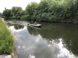 Rob and his son paddle their kayak down the canal.