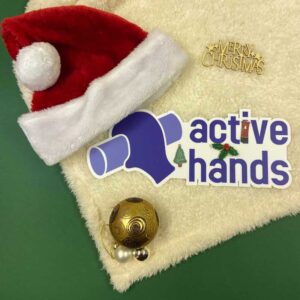 active hands logo on green background with santa hat and bauble