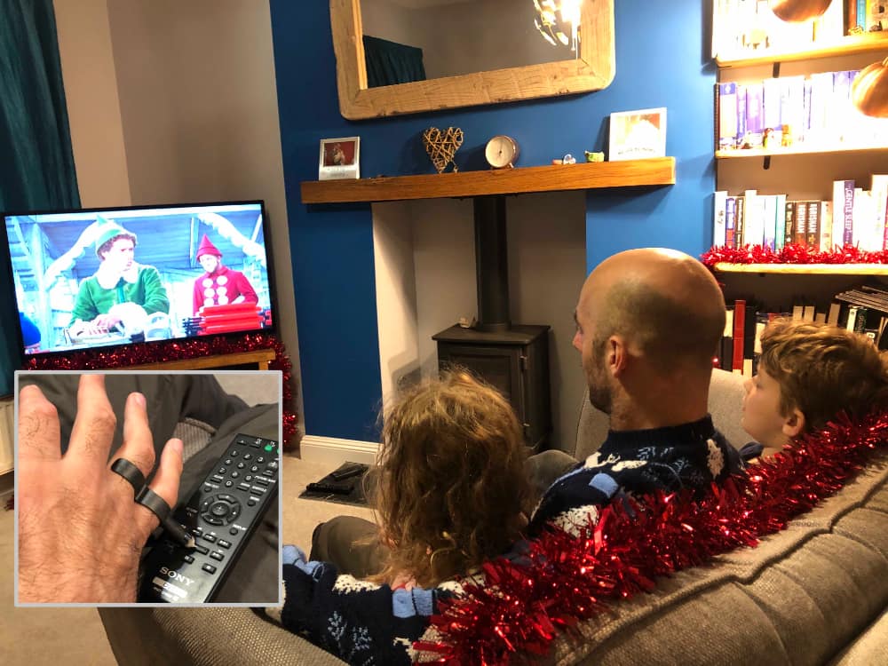 Rob and his family watching tv using the sixth digit 2 to operate the controller