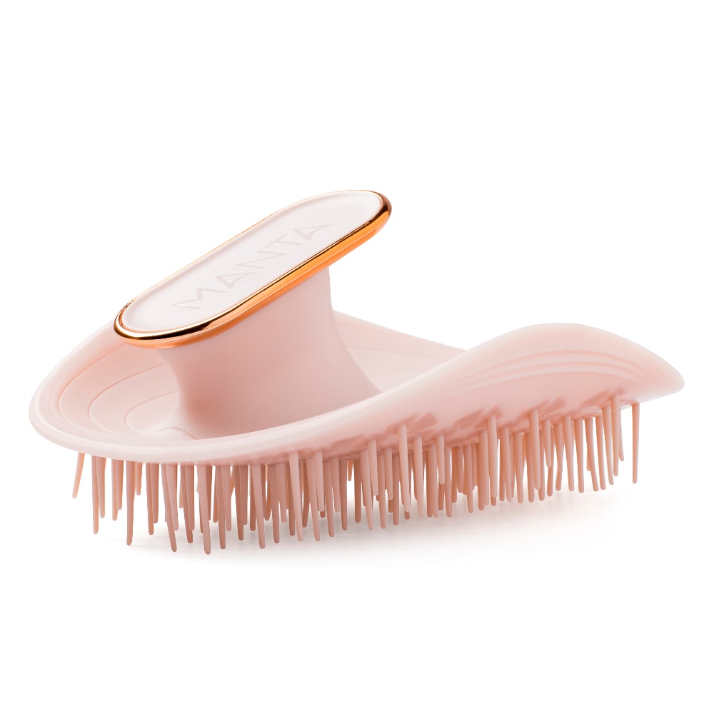 The Manta hair brush in pink with a rose gold edging around the 'handle'