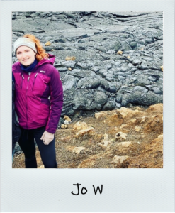 Jo W standing in front of a lava field