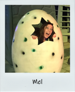 our Director Mel, inside a giant pretend dinosaur egg!