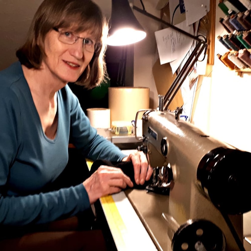 Shirley working on her sewing machine at home