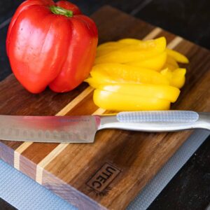 A strip of clear grip strip stuck on a kitchen knife handle to give a safer hold