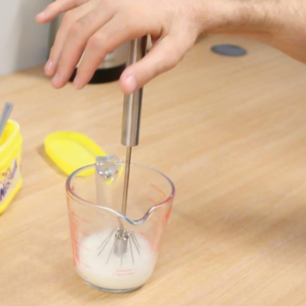 push whisk being used to mix milkshake