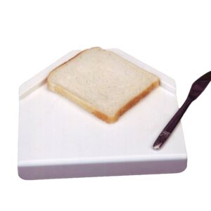 Sandwich prep board with white bread and a knife
