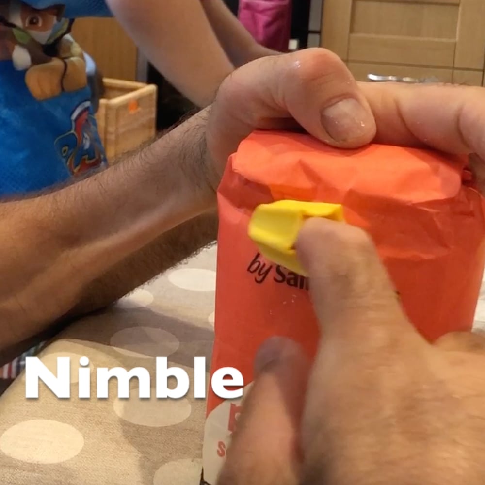 Nimble being used to open a packet of flour
