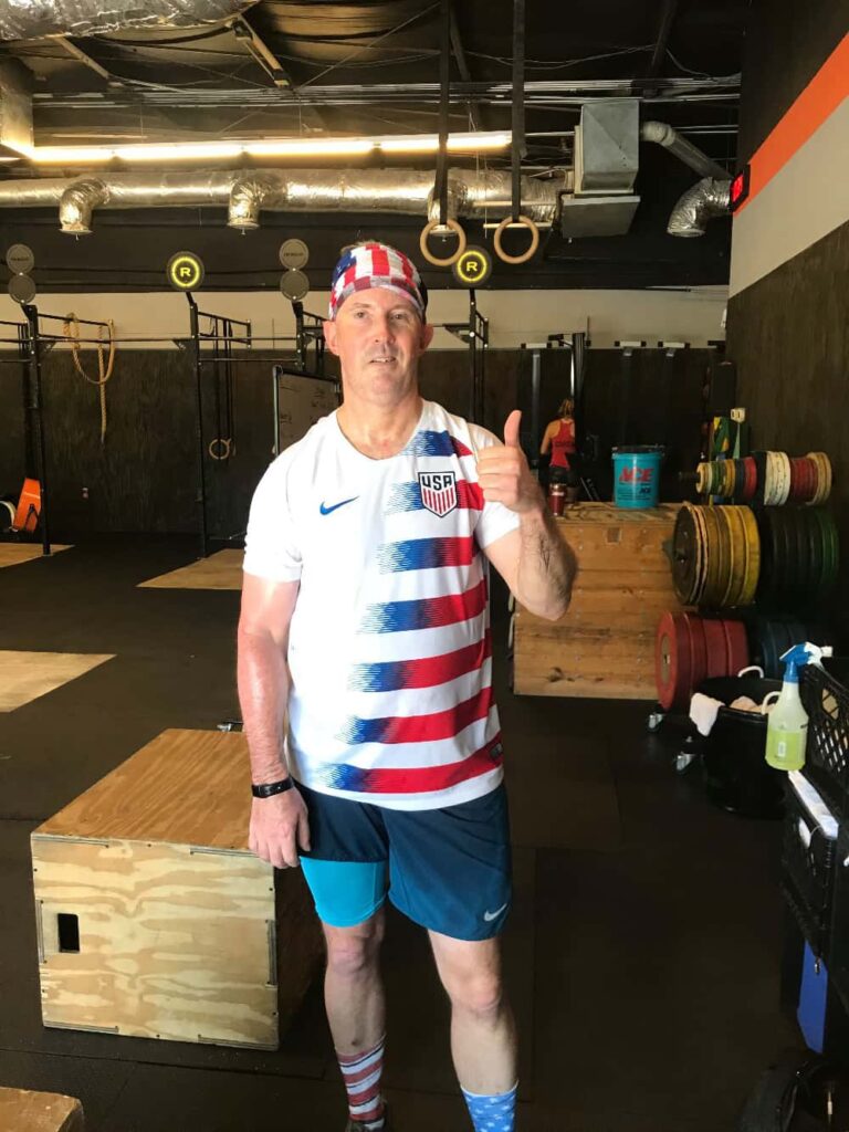 Paul Dewey giving a thumbs up that his General Purpose aid has allowed him to return to CrossFit after having a major stroke