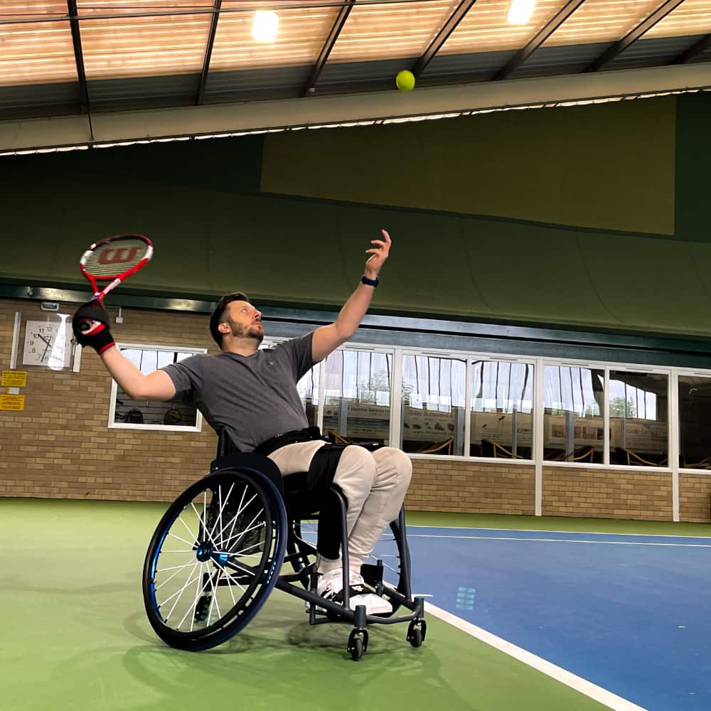 James serving in tennis with the angled aid