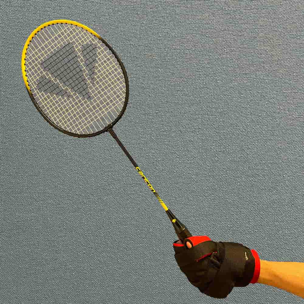 Angled Aid being used to hold a badminton racket
