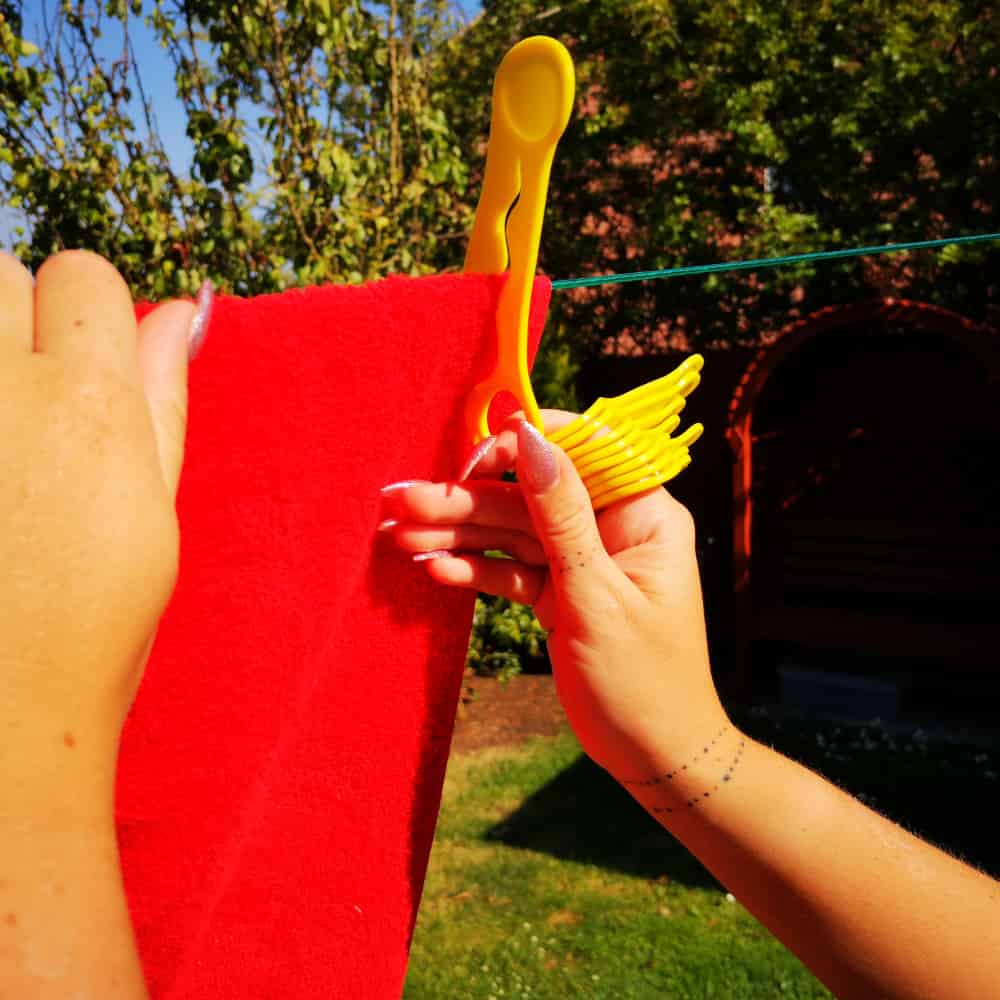 hand showing how easy it is to attach a wiggly peg to your washing